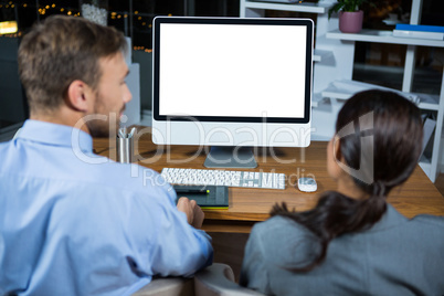 Business executives working on computer