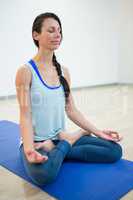 Woman practicing yoga in lotus position
