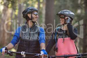 Biker couple smiling and looking at each other