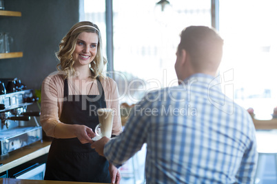 Waitress serving a cup of cold coffee to customer