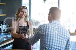 Waitress serving a cup of cold coffee to customer