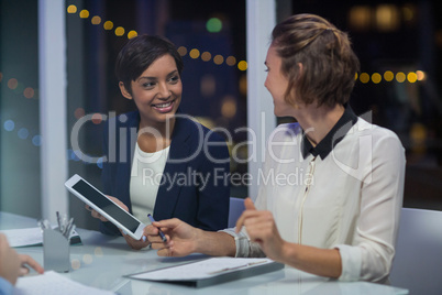 Businesswomen interacting with each other in conference room