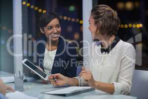 Businesswomen interacting with each other in conference room