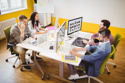 High angle view of photo editors working at creative office