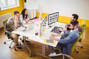 High angle view of photo editors working at creative office