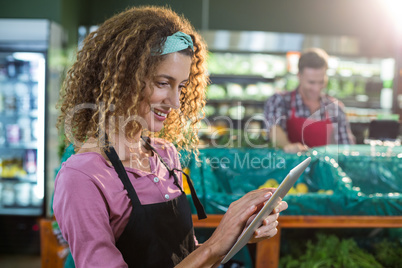 Female staff using digital tablet in organic section