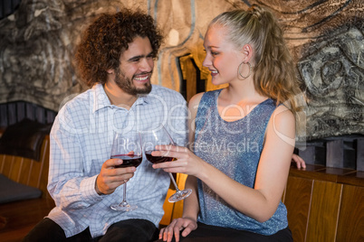 Couple toasting glass of wine in bar