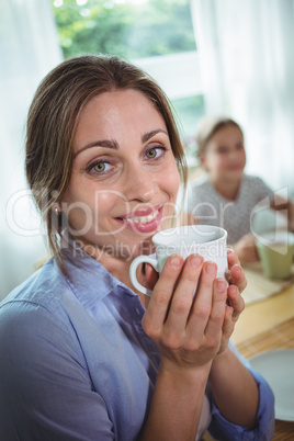 Smiling woman having coffee