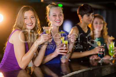 Friends having glass of cocktail in bar