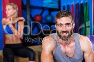 Portrait of cheerful young man in gym