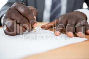 Hands of a man signing document