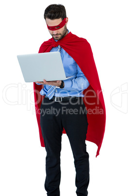 Businessman pretending to be a super hero using laptop