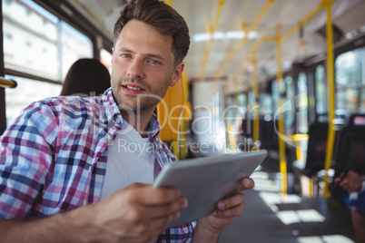 Portrait of handsome man using digital tablet