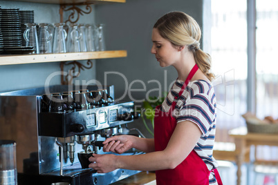 Waitress making cup of coffee