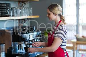 Waitress making cup of coffee