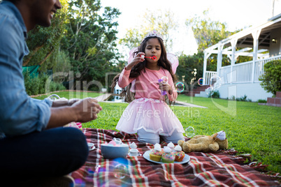 Girl blowing soap bubbles