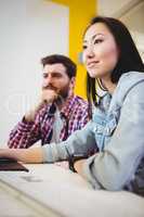 Businesswoman with male coworker at desk