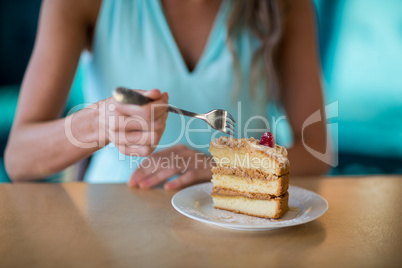 Woman eating dessert in cafe