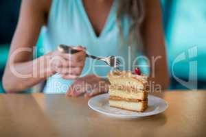 Woman eating dessert in cafe