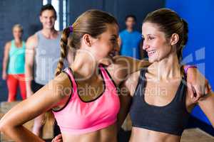 Smiling female athletes in fitness studio