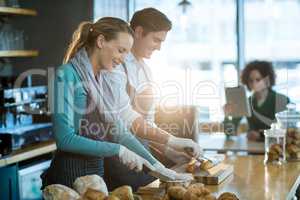 Waiter and waitress working at counter in cafÃ?Â©