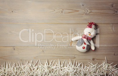 Snowman and small candles on wooden table