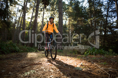 Female biker cycling in countryside