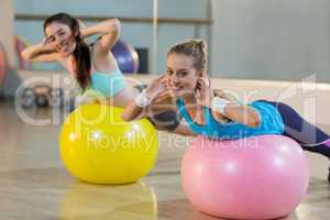 Two women exercising on exercise ball