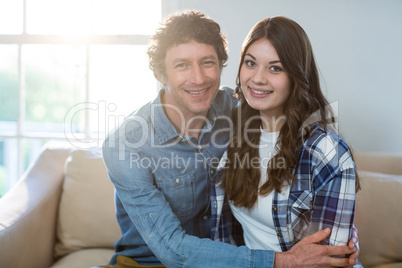 Couple sitting together on sofa