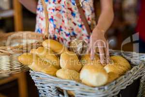 Mid section of woman selecting bread