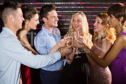 Group of friends toasting glasses of champagne