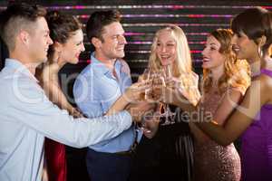 Group of friends toasting glasses of champagne