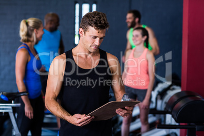 Gym trainer with clipboard