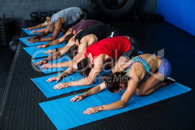 Athletes stretching while kneeling