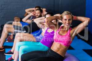 Woman smiling while exercising in fitness studio