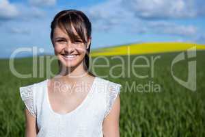 Happy young woman standing in field