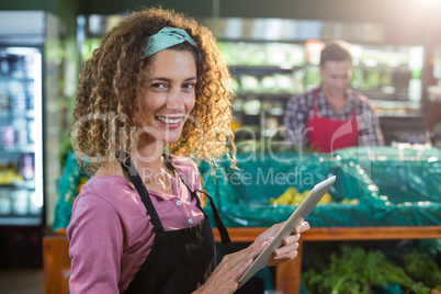 Female staff using digital tablet in organic section