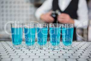 Glass of blue lagoon drinks on bar counter