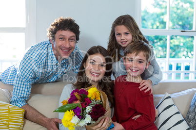 Portrait of happy family with flower bouquet