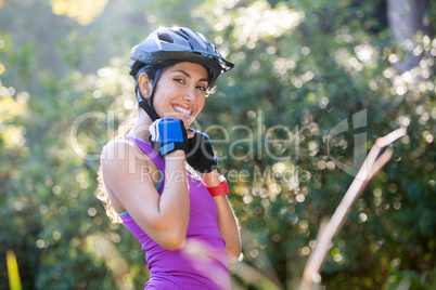 Female athletic wearing bicycle helmet in countryside