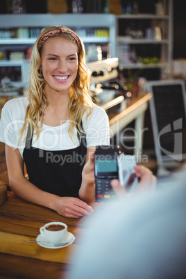 Customer paying bill through smartphone using NFC technology