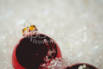 Close-up of christmas baubles on snow