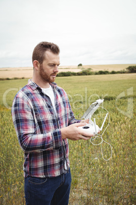 Farmer using agricultural device while examining in field