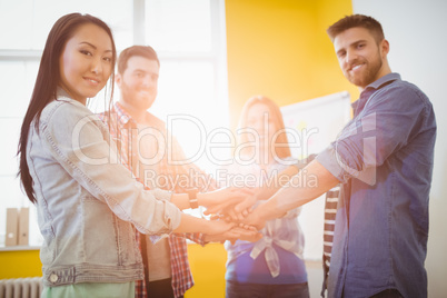 Portrait of smiling business people stacking hands