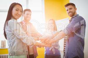 Portrait of smiling business people stacking hands
