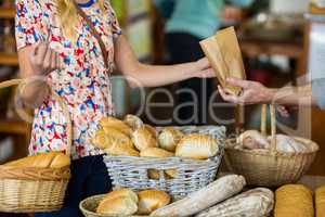 Mid section of woman purchasing bread