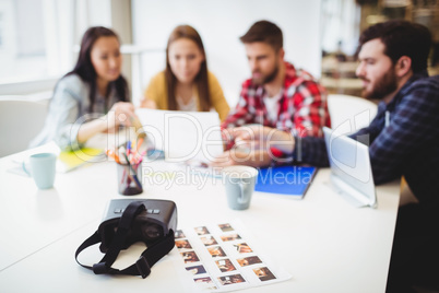 Photos with virtual reality headset on table against photo editors