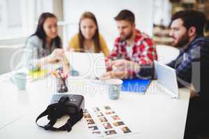 Photos with virtual reality headset on table against photo editors