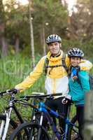 Biker couple with mountain bike in countryside