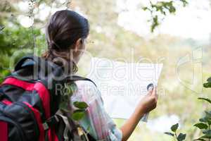 Female hiker looking at map